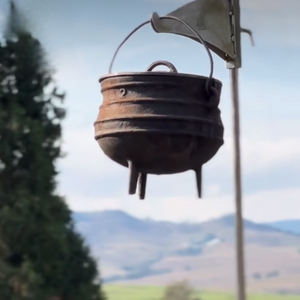 Potjie pot hanging on Smokeless Fires potjie holder