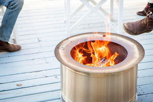 Smokeless firepit burning on wooden deck