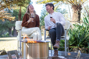 Cople laughing near smokeless firepit